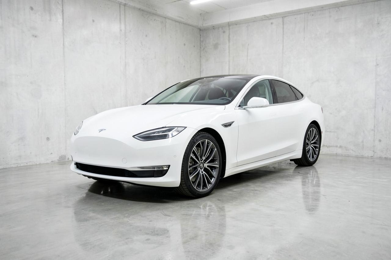 White 2023 Tesla Model S Plaid, front three-quarter view in a showroom